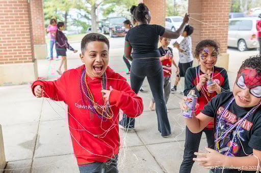 students celebrating outside of school