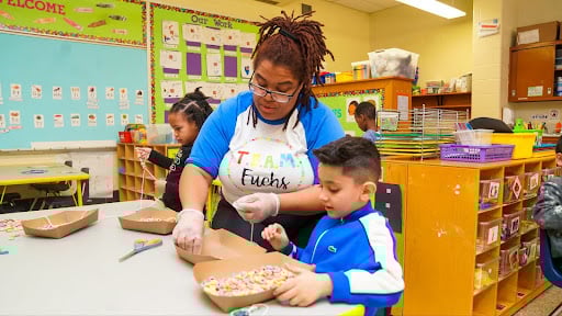 teacher helping student with hands-on activity