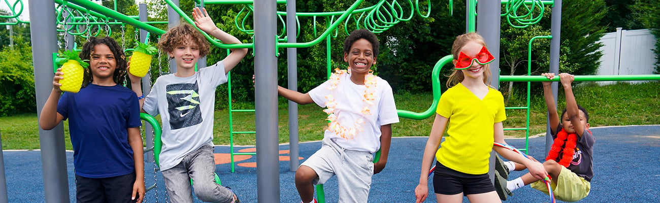 students on playground with summer drinks, glasses and leis