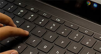 hand typing on computer keyboard