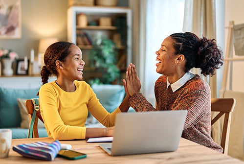 parent-student-giving-high-five-smiling-with-laptop-computer